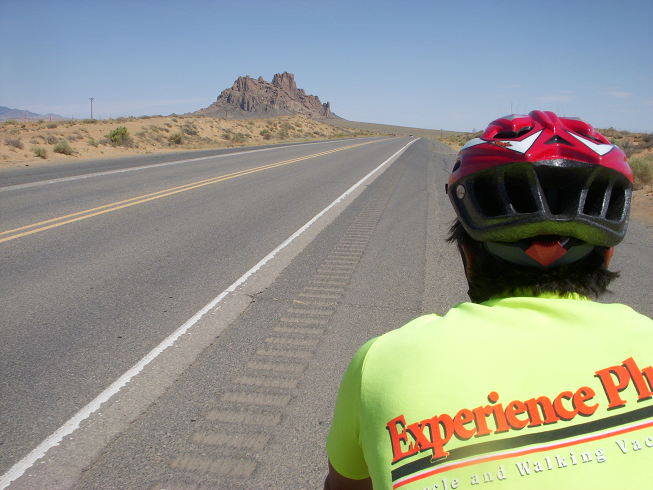 Photo is from Christi's perspective, which is the stoker position, the person in the back.  We are on a quiet, desert highway in northwestern New Mexico with nothing except a desert mountain in the distance.  Tauru's bright yellow jersey and red helmet is in the right side of the photo.  This is what Christi sees all day long.